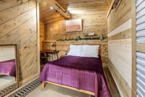 Bedroom with bed tucked in a corner